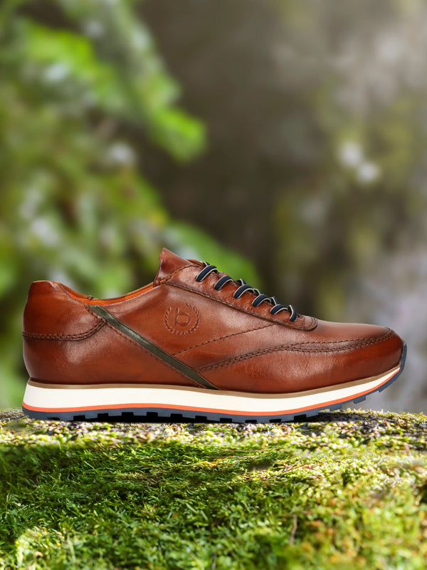 A cognac Men's bugatti Sneakers featuring a round toe plain toe, zero heels heel. Made from premium genuine leather with a durable eva outsole, this laces design offers both style and comfort.
