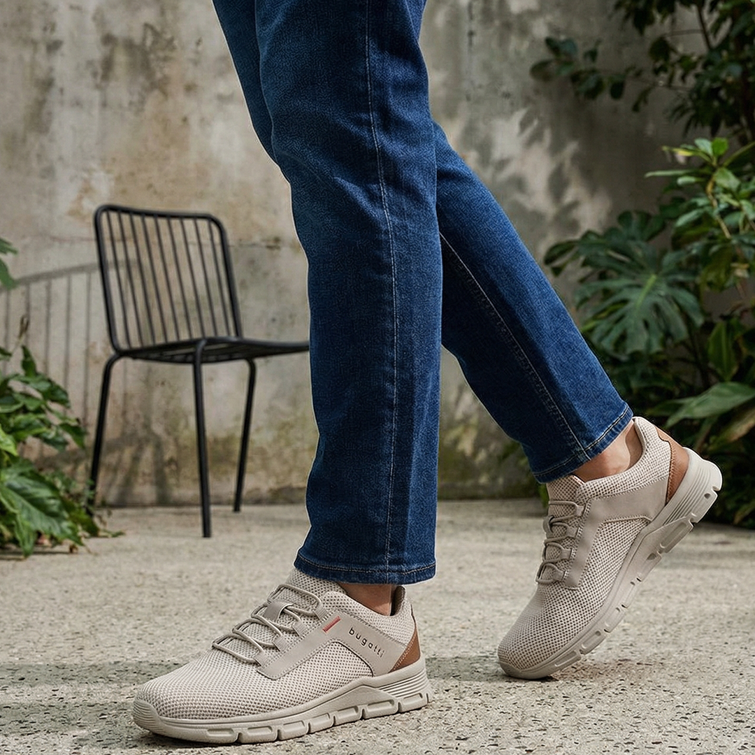 Lifestyle shot of the bugatti Nexon Beige Comfort Mid Top Sneakers on a person wearing jeans.
