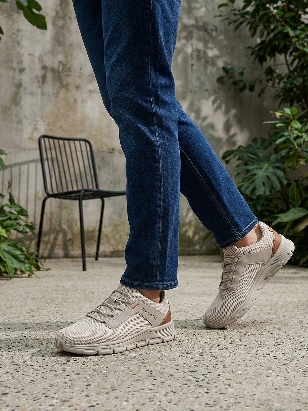 Lifestyle shot of the bugatti Nexon Beige Comfort Mid Top Sneakers on a person wearing jeans.
