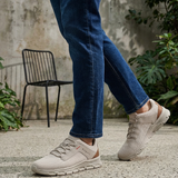 Lifestyle shot of the bugatti Nexon Beige Comfort Mid Top Sneakers on a person wearing jeans.
