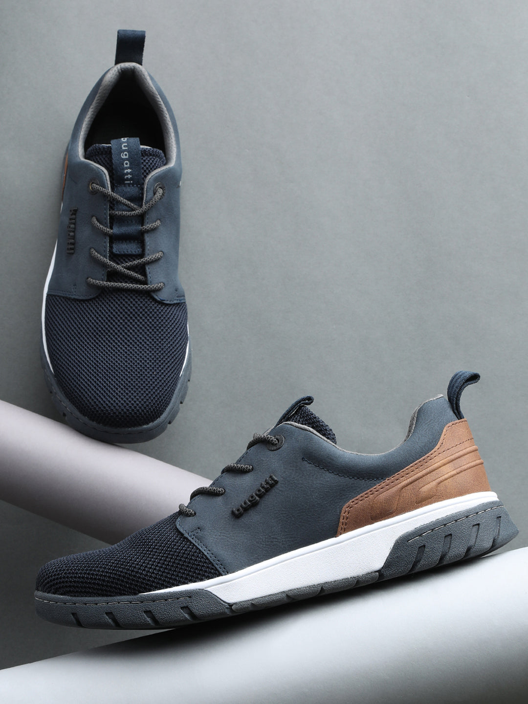 A blue Men's bugatti Sneakers featuring a round plain toe, zero heels heel. Made from textile with a durable eva outsole, this laces design offers both style and comfort.