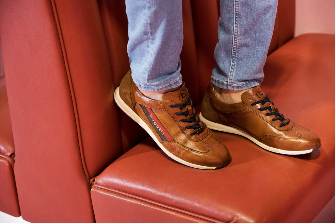 A cognac Men's bugatti Sneakers featuring a round plain toe, zero heels heel. Made from premium genuine leather with a durable tr outsole, this slip-on design offers both style and comfort.