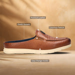 A cognac Men's bugatti Mules featuring a round plain toe, zero heels heel. Made from premium genuine leather with a durable eva outsole, this slip-on design offers both style and comfort.