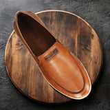 A cognac Men's bugatti Casual Loafers featuring a round toe apron toe, zero heels heel. Made from premium genuine leather with a durable tpr outsole, this slip-on design offers both style and comfort.